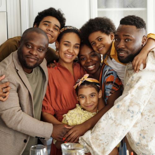 Family huddling together for a picture.
