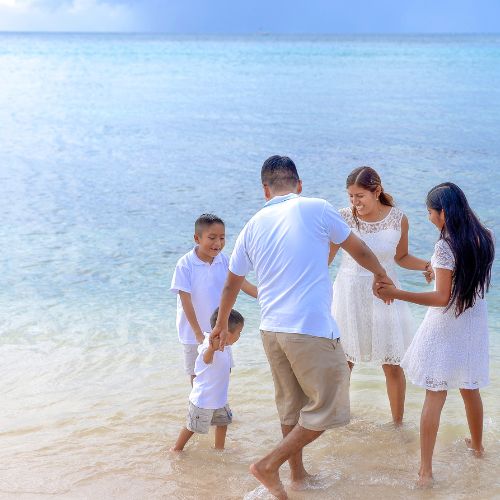 Family playing along the sea shore